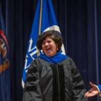 President Mantella laughs with woman on stage